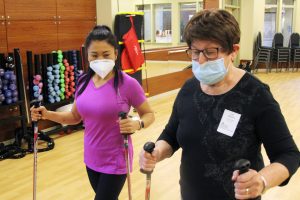 Nancy Thenthongkham, physical therapist assistant, explains how to use urban poles 